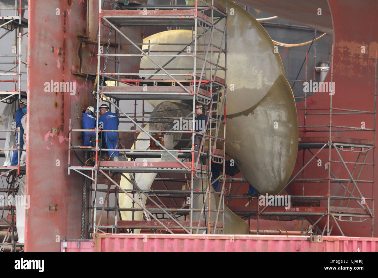 Engineers working on a ships propeller in dry dock Stock Photo