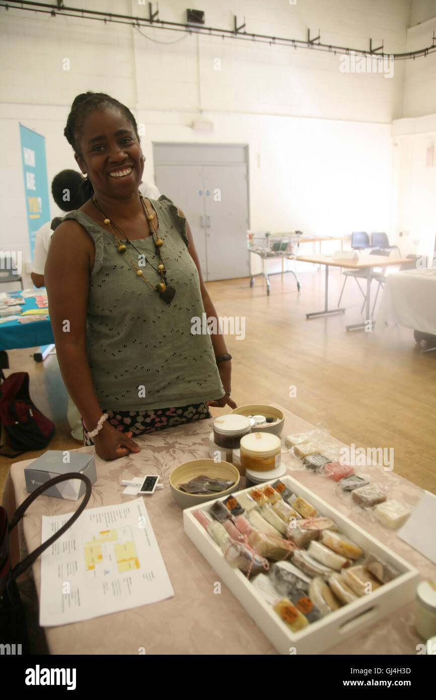 England, London , Chestnuts Community Centre, a lady promoting her home-made natural skin therapy products. Stock Photo