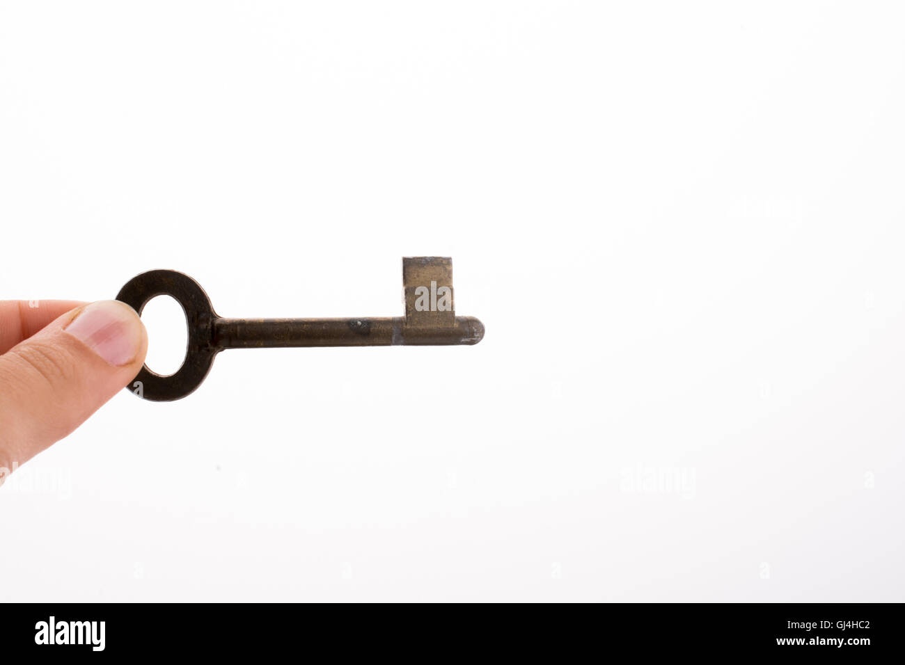 Hand holding a key on a white background Stock Photo - Alamy