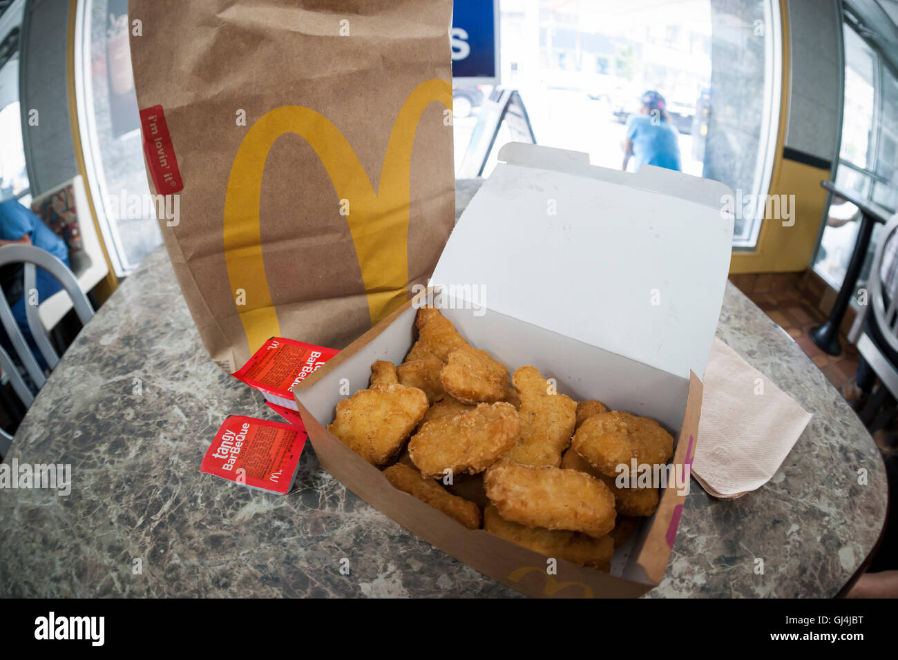 An order of McDonald's Chicken McNuggets in a McDonald's restaurant in New York on Monday, August 1, 2016. McDonald's announced that it has dropped the artificial preservative used in McNuggets cooking oil and and they have removed much of the artificial ingredients contained in the McNuggets. The company also has stopped the use of chickens raised with antibiotics and will remove high fructose corn syrup from its buns, replacing it with sugar.  (© Richard B. Levine) Stock Photo