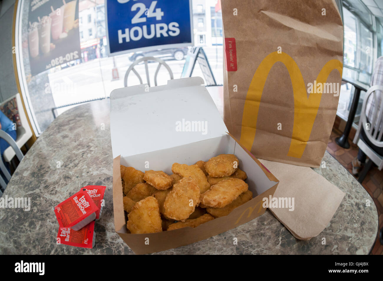 An order of McDonald's Chicken McNuggets in a McDonald's restaurant in New York on Monday, August 1, 2016. McDonald's announced that it has dropped the artificial preservative used in McNuggets cooking oil and and they have removed much of the artificial ingredients contained in the McNuggets. The company also has stopped the use of chickens raised with antibiotics and will remove high fructose corn syrup from its buns, replacing it with sugar.  (© Richard B. Levine) Stock Photo
