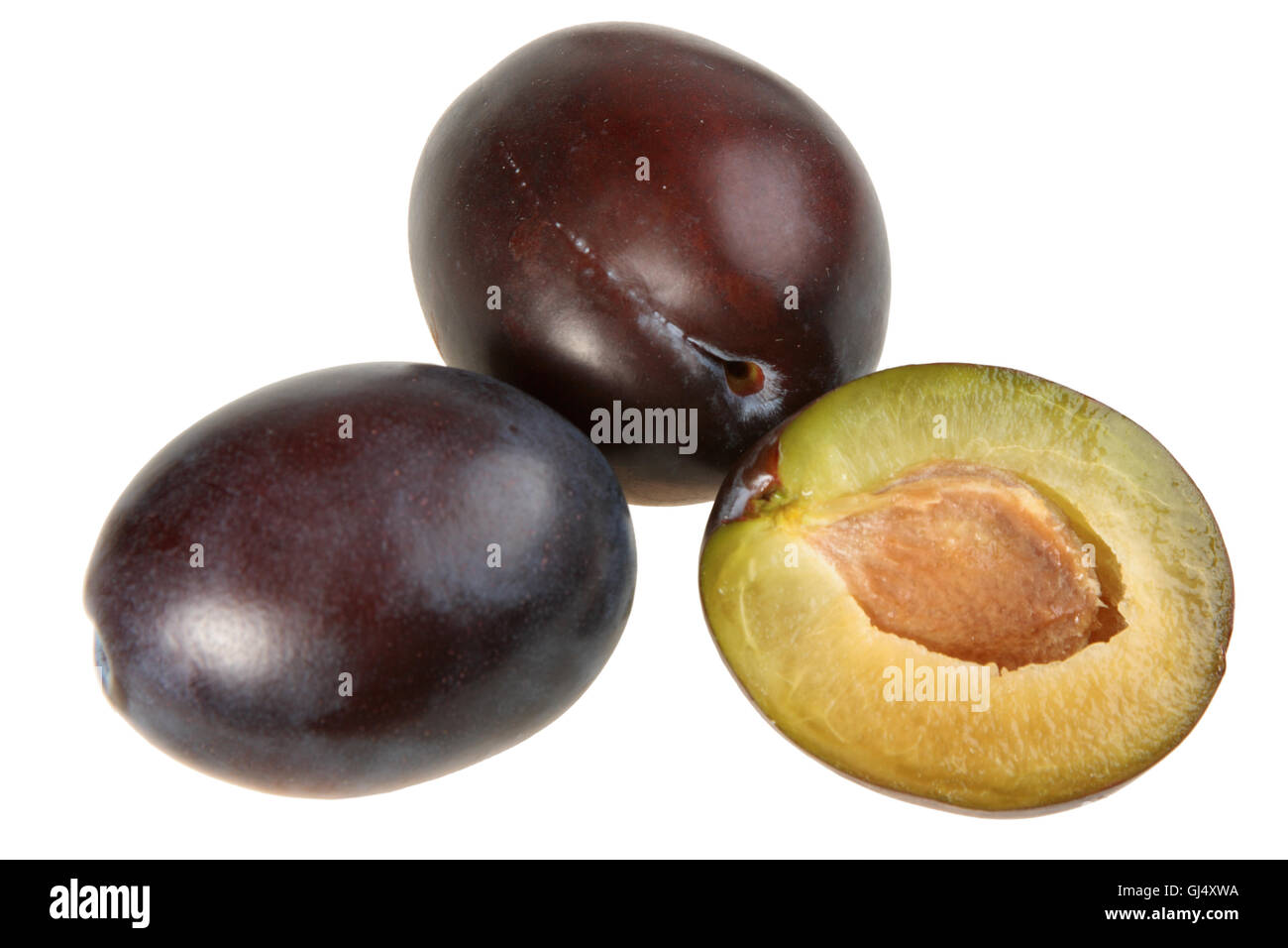 Three darkpurple plums Stock Photo Alamy
