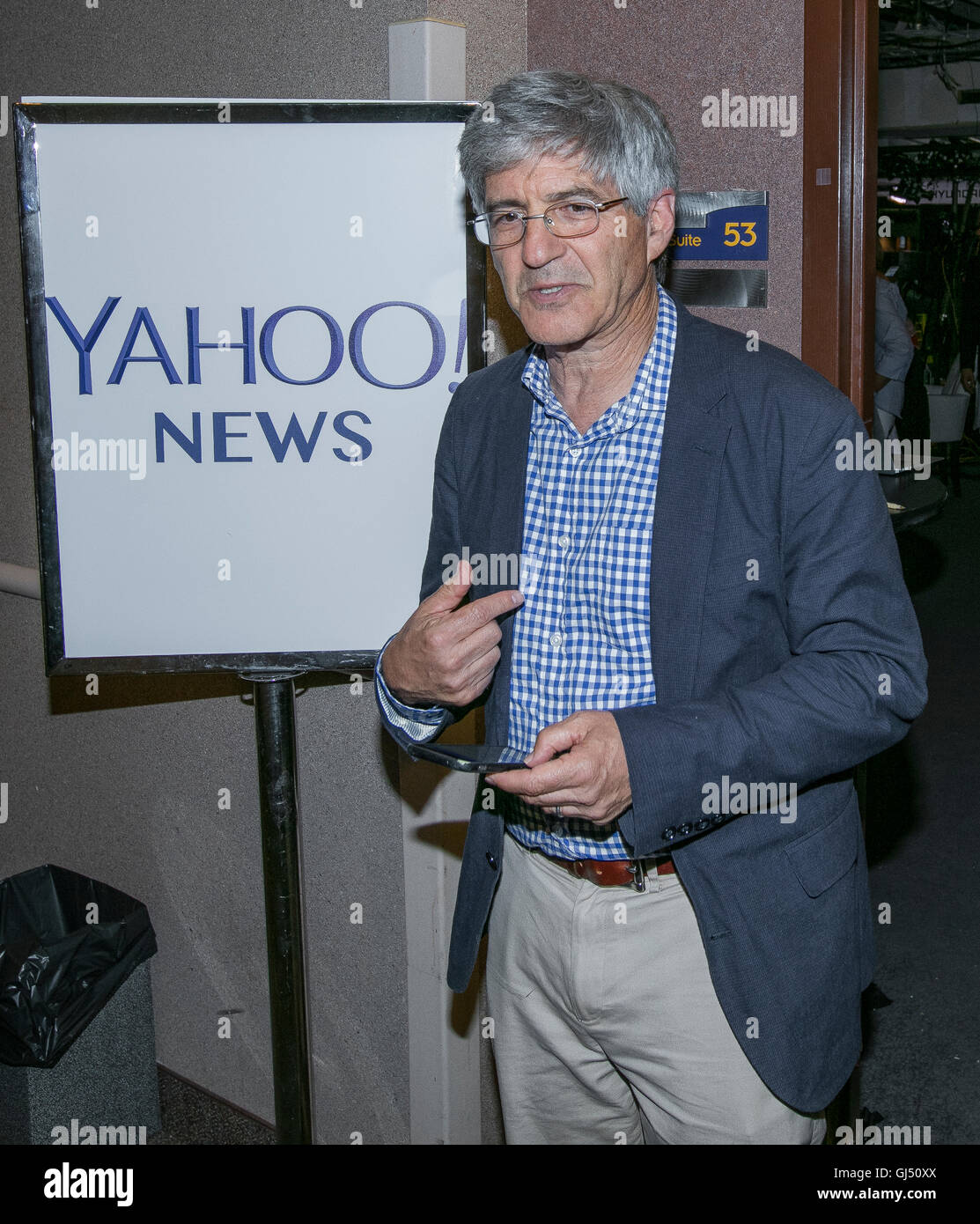 Philadelphia, Pennsylvania, USA, 28th July, 2016 YAHOO News reporter Michael Isikoff checking his text messages as he walks out of the YAHOO television broadcast booth at the DNC.  Credit: Mark Reinstein Stock Photo