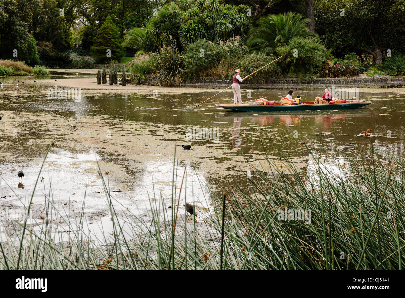 Family on a punting tour on Ornamental Lake in the Royal Botanic Gardens Melbourne. Stock Photo
