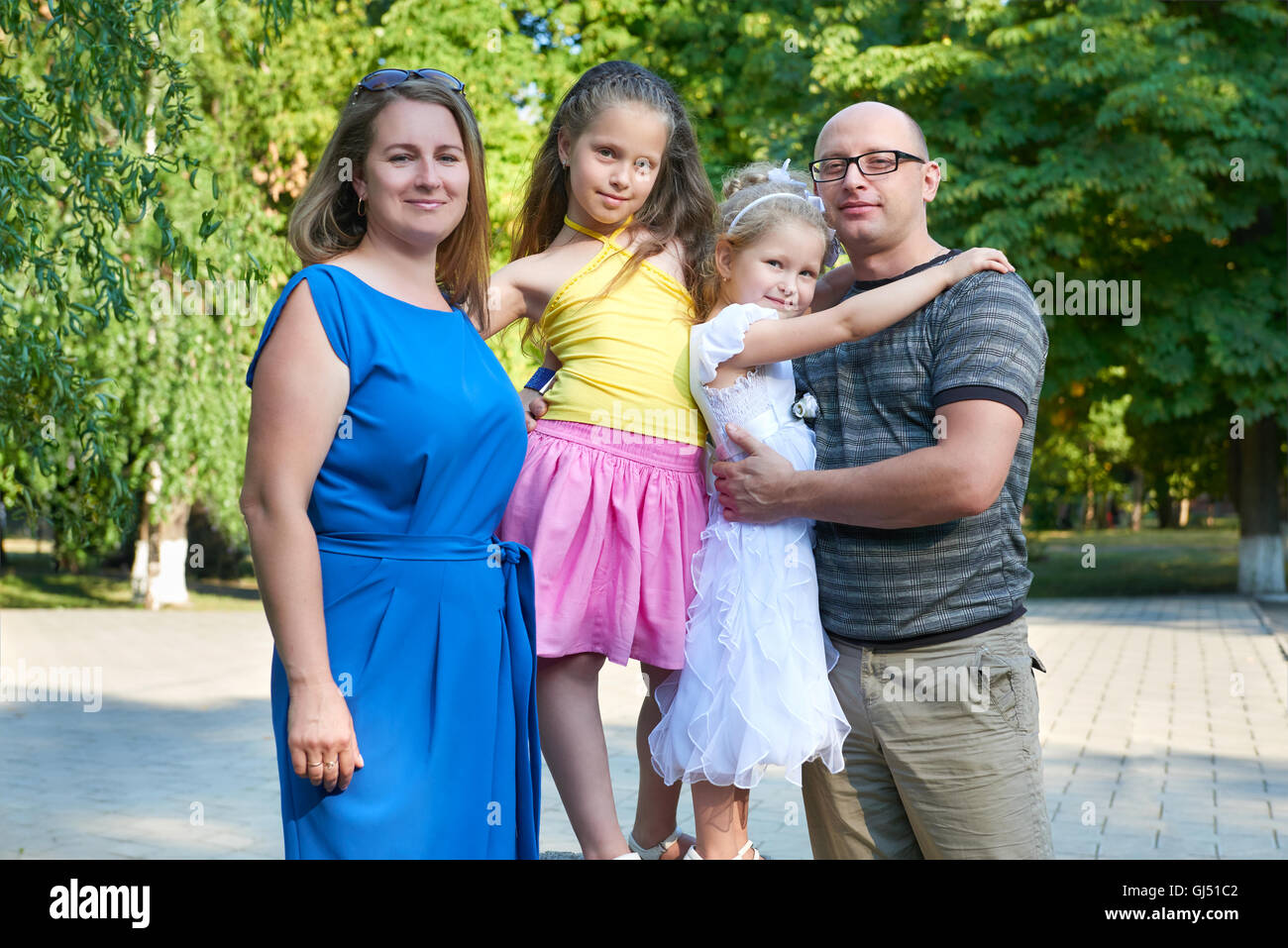 happy family portrait on outdoor, group of four people posing in park ...