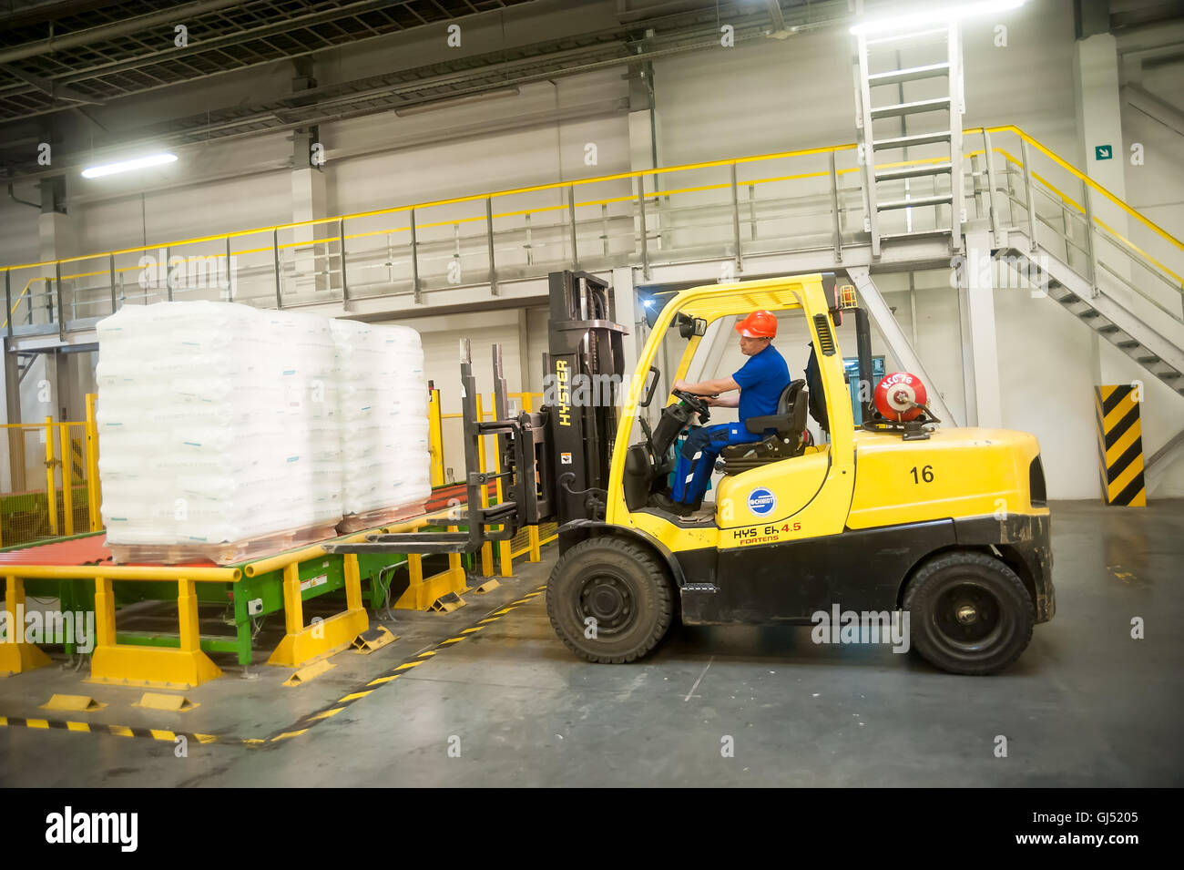 Forklift truck loads pallets with finished goods Stock Photo Alamy