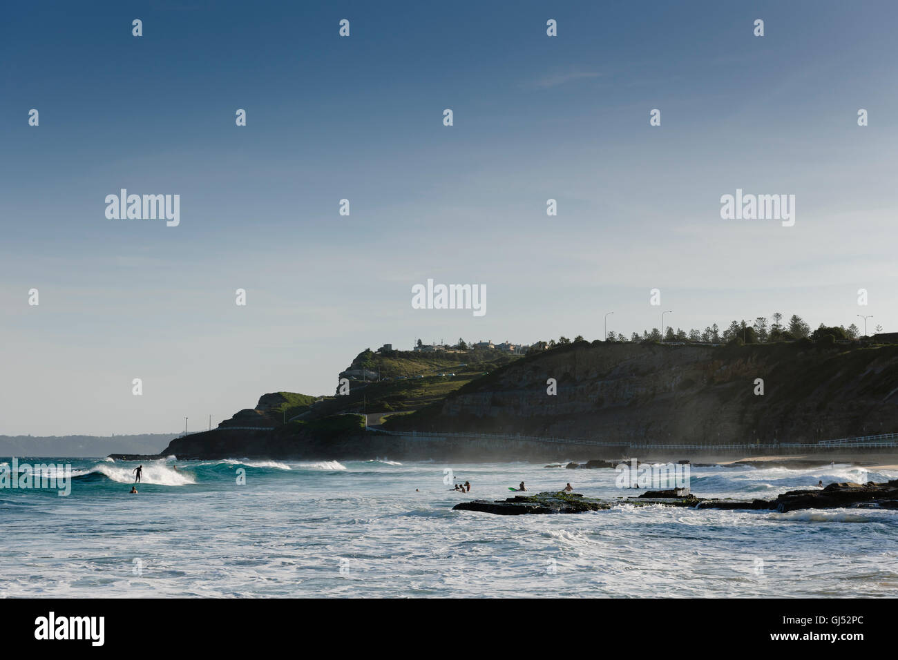 People surfing at Newcastle Beach, New South Wales, Australia. Stock Photo