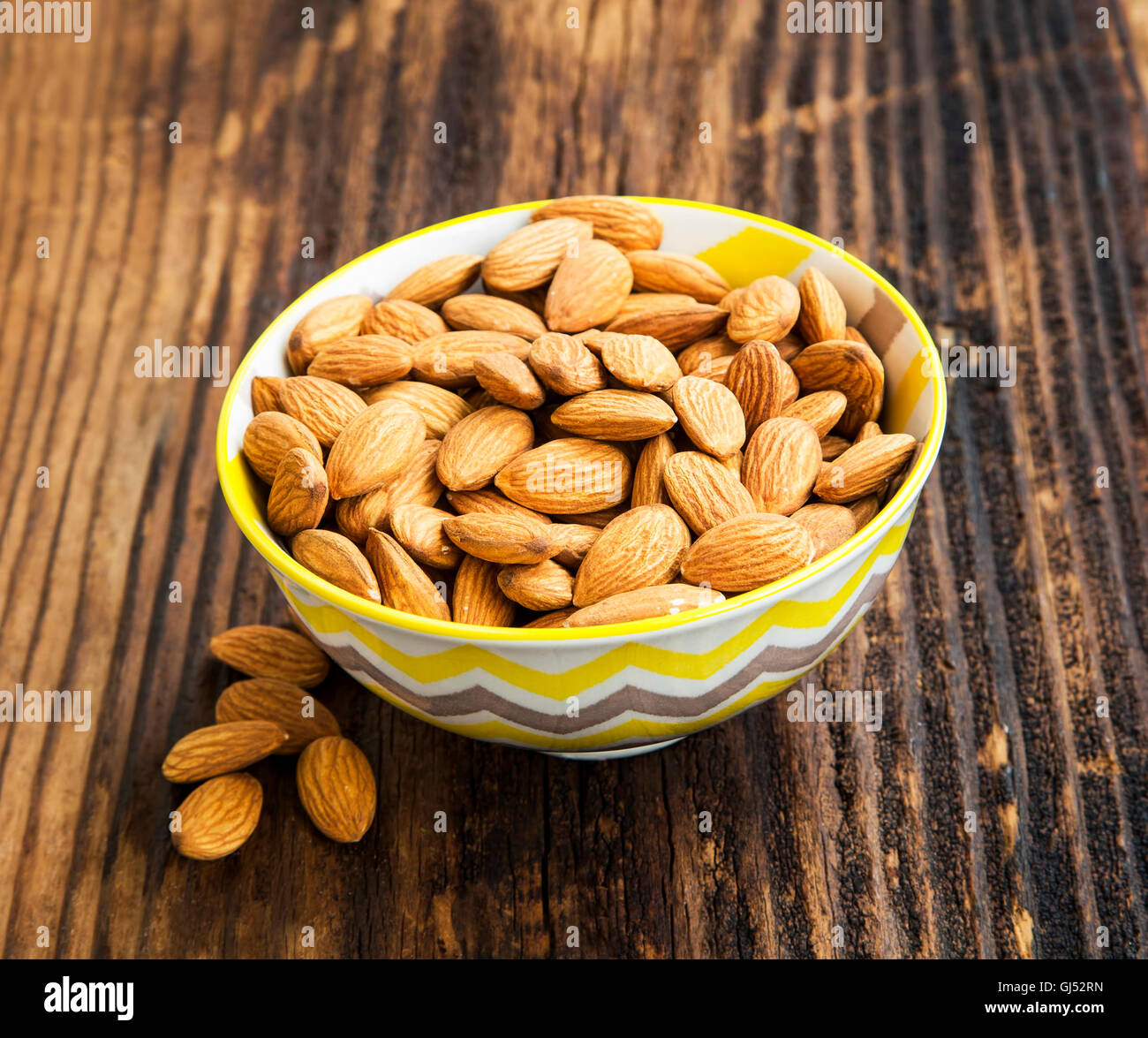Bowl of healthy fresh almonds on wooden background,healthy nuts Stock Photo