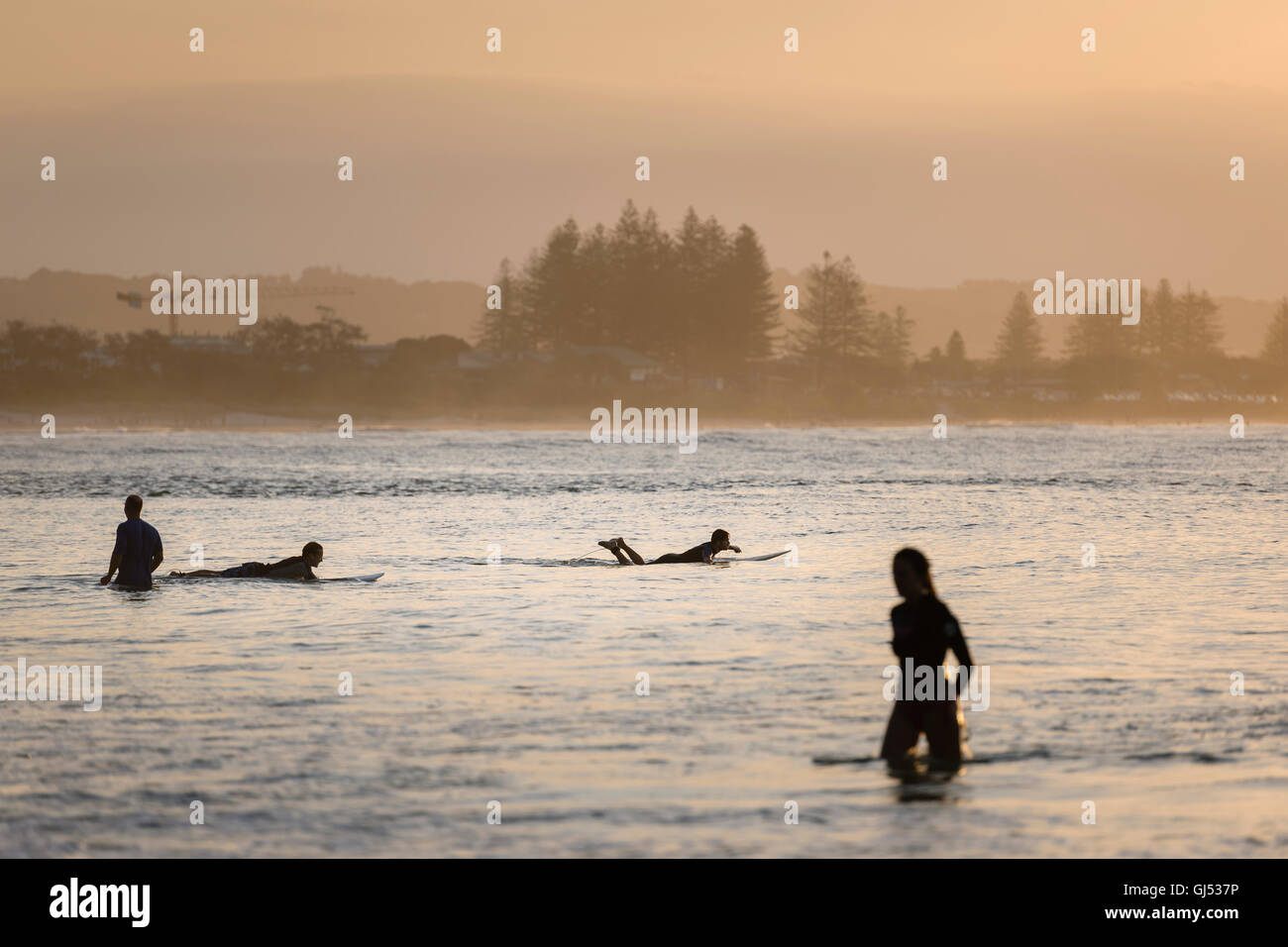 People surfing at Byron Beach in Byron Bay. Stock Photo