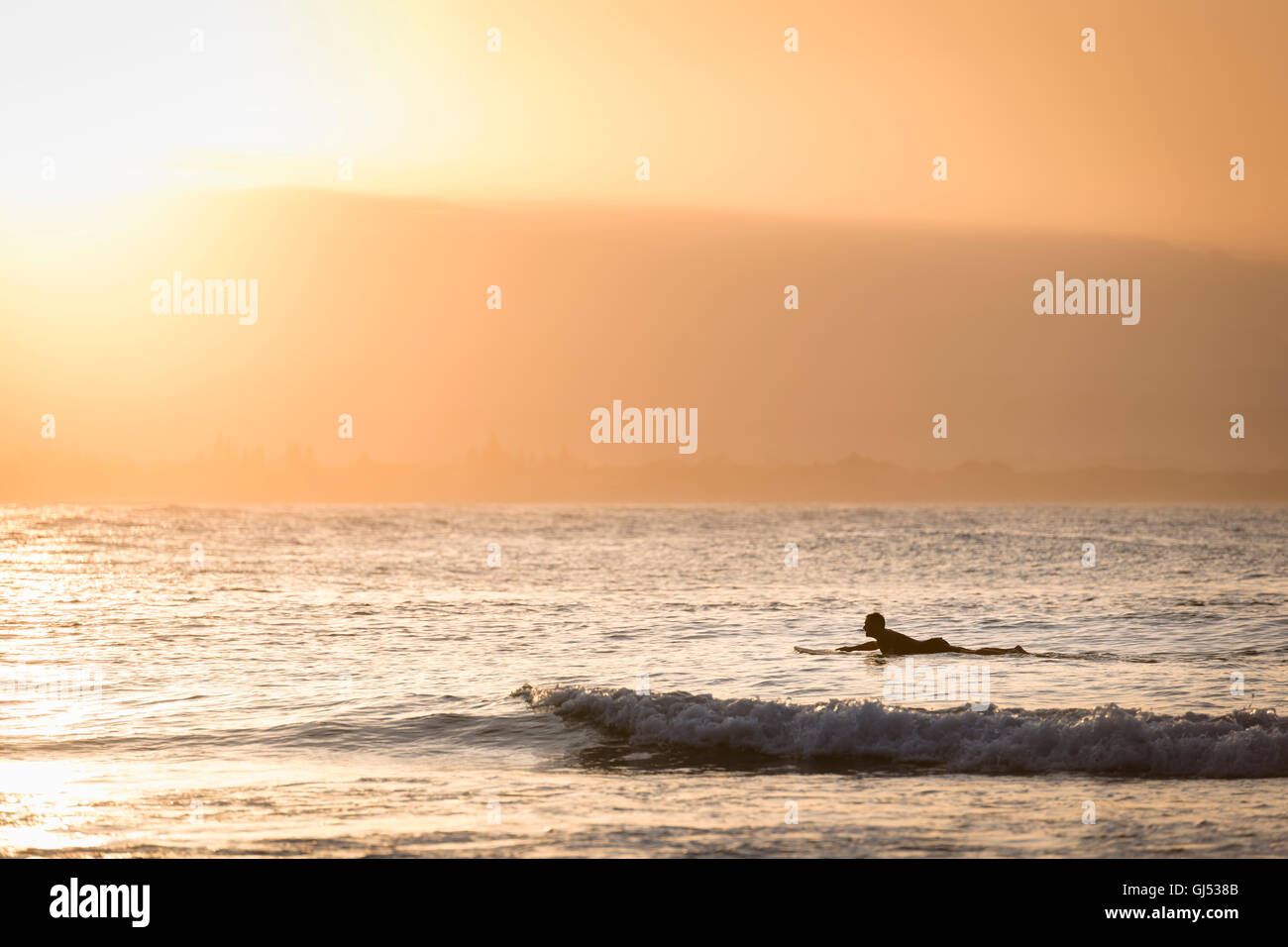 Man surfing at Byron Beach in Byron Bay. Stock Photo
