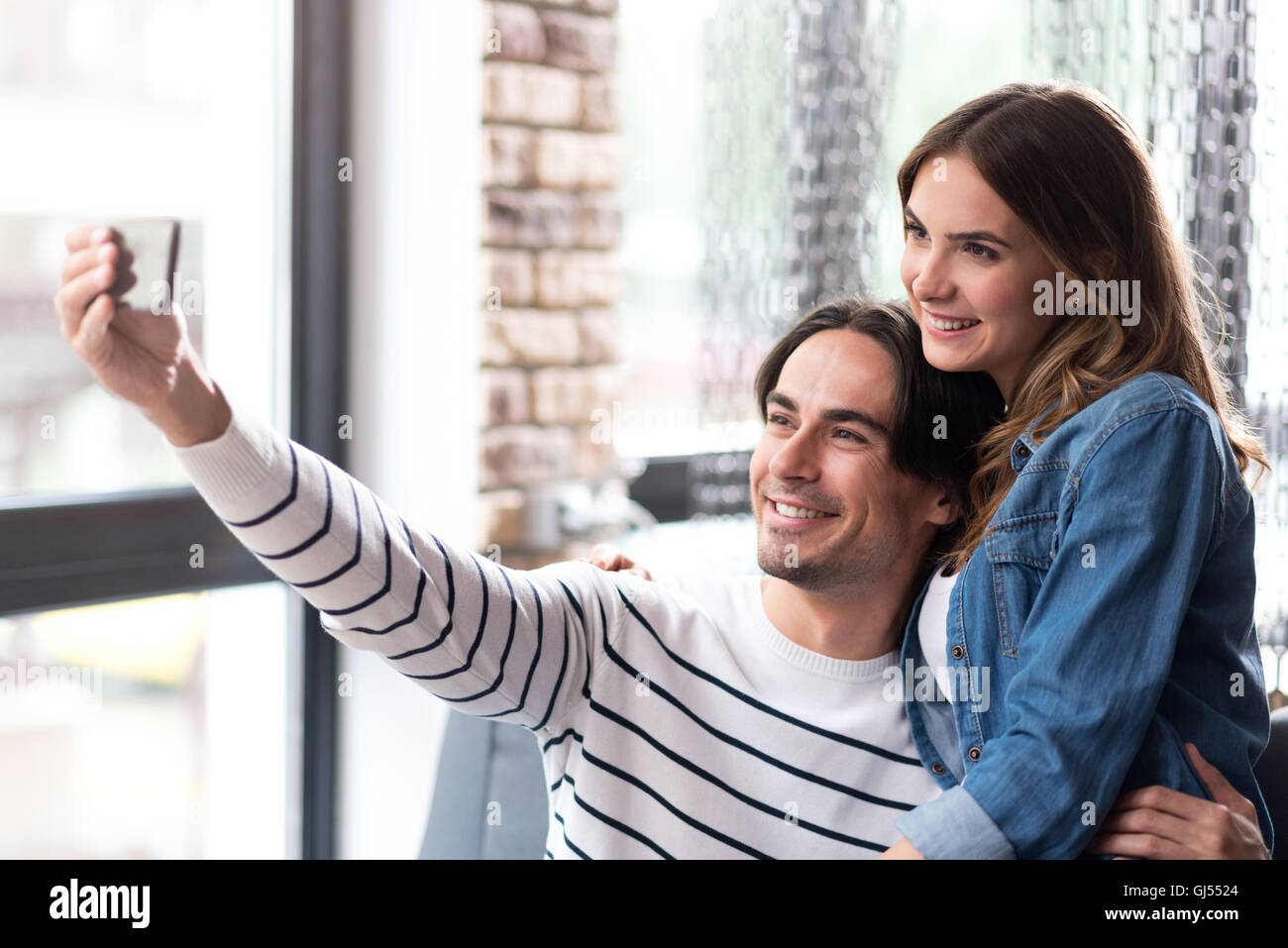Cheerful couple making selfies Stock Photo - Alamy