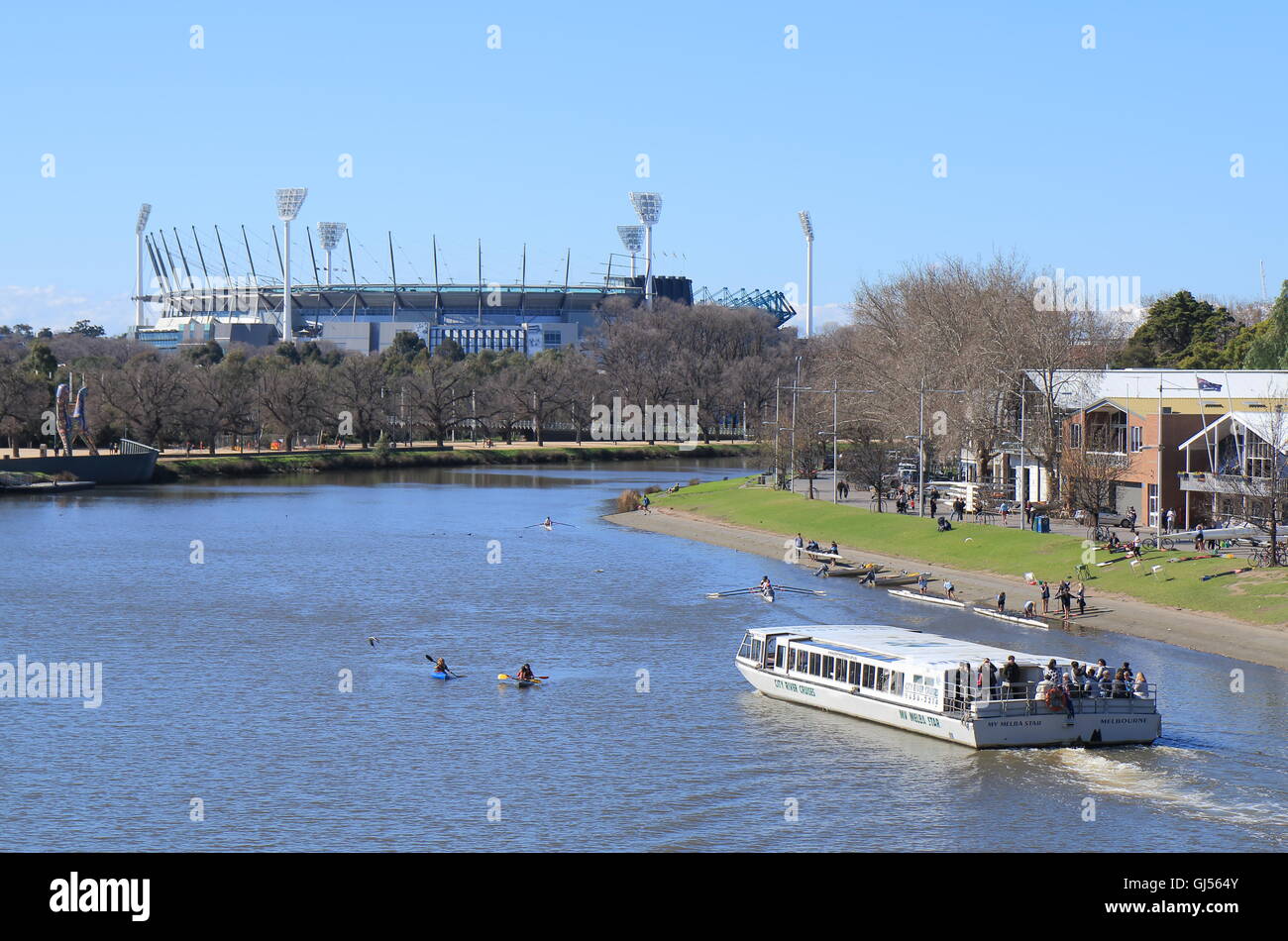 Sightseeing boat cruises in Yarra river MCG in background in Melbourne Australia. Stock Photo