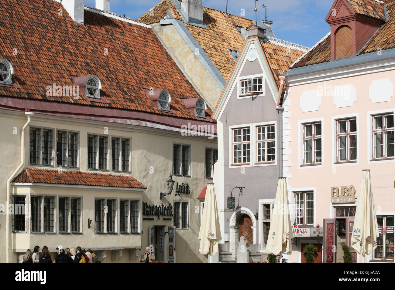 Medieval merchant houses ring Town Hall Square, Raekoja Plats, in the Old Town of Tallinn. The building on the left is Raeapteek Stock Photo