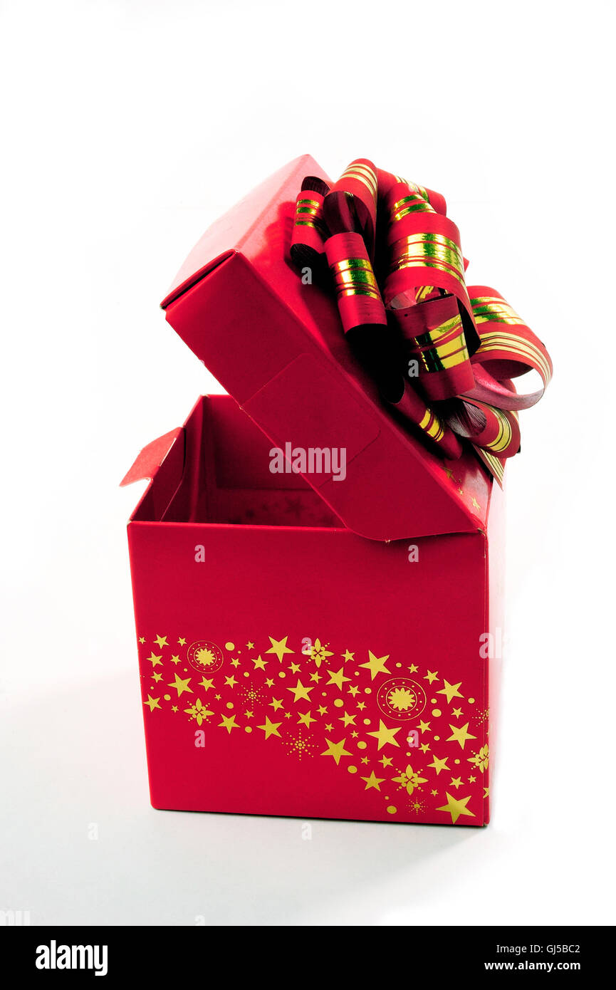 A red gift box with a red bow and gold Stock Photo - Alamy