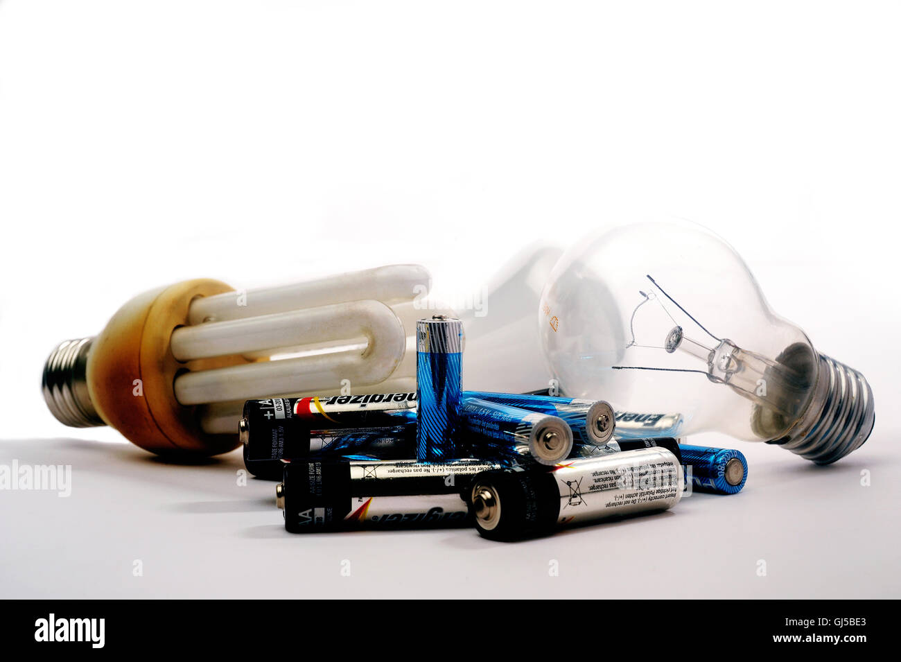 Recycling of used batteries and bulbs on white background Stock Photo