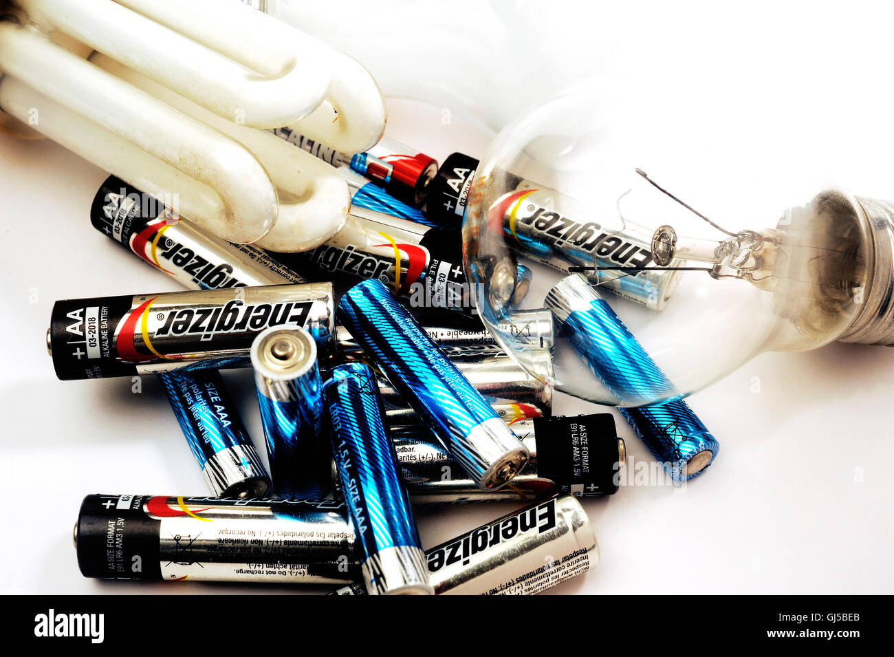 Recycling of used batteries and bulbs on white background Stock Photo