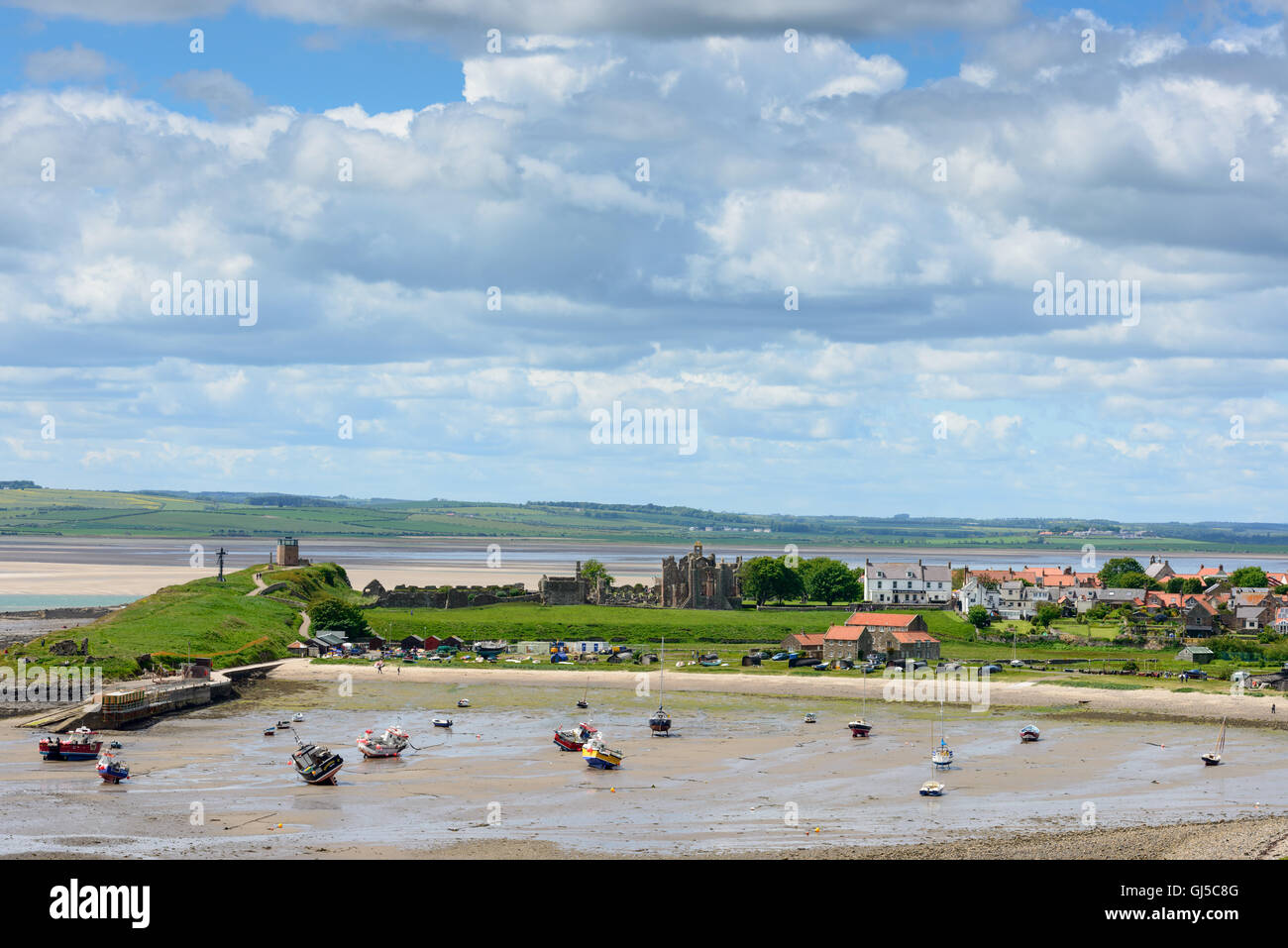 Lindisfarne village, harbour and monastery, Northumberland, with mainland behind Stock Photo