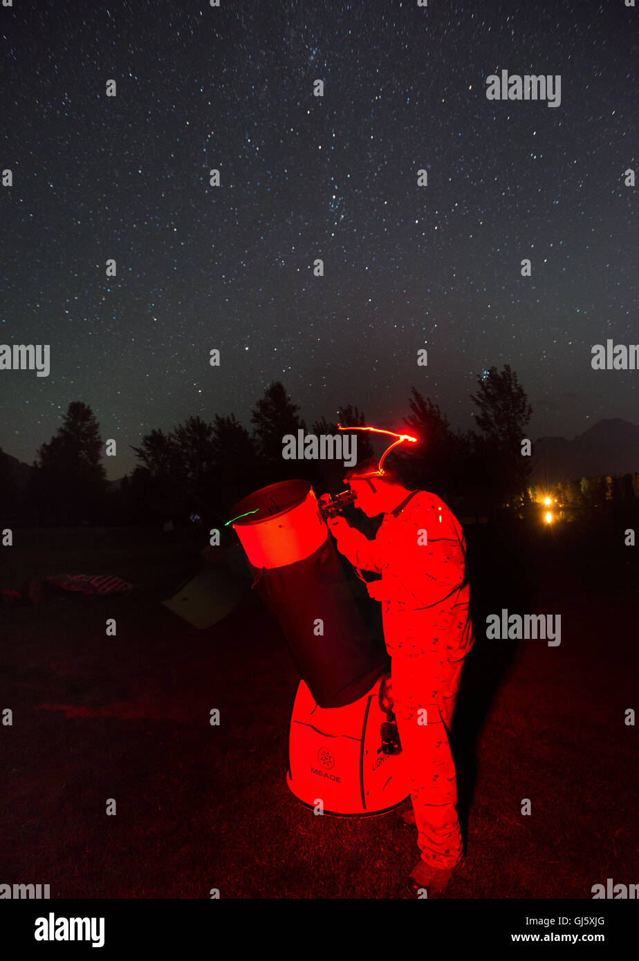 An astronomer sets his telescope to view the Perseid meteor shower, reportedly the heaviest one in the last twenty years. Stock Photo