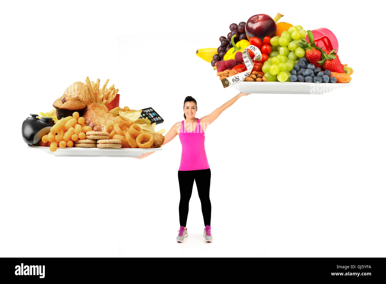 Unhealthy or healthy lifestyle and food  concept healthy young woman with plates of healthy and unhealthy food as weigh scales Stock Photo