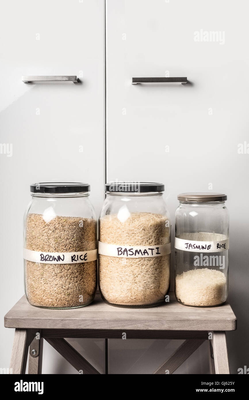 Raw Brown rice, basmati rice and jasmine rice variety in jars Stock ...