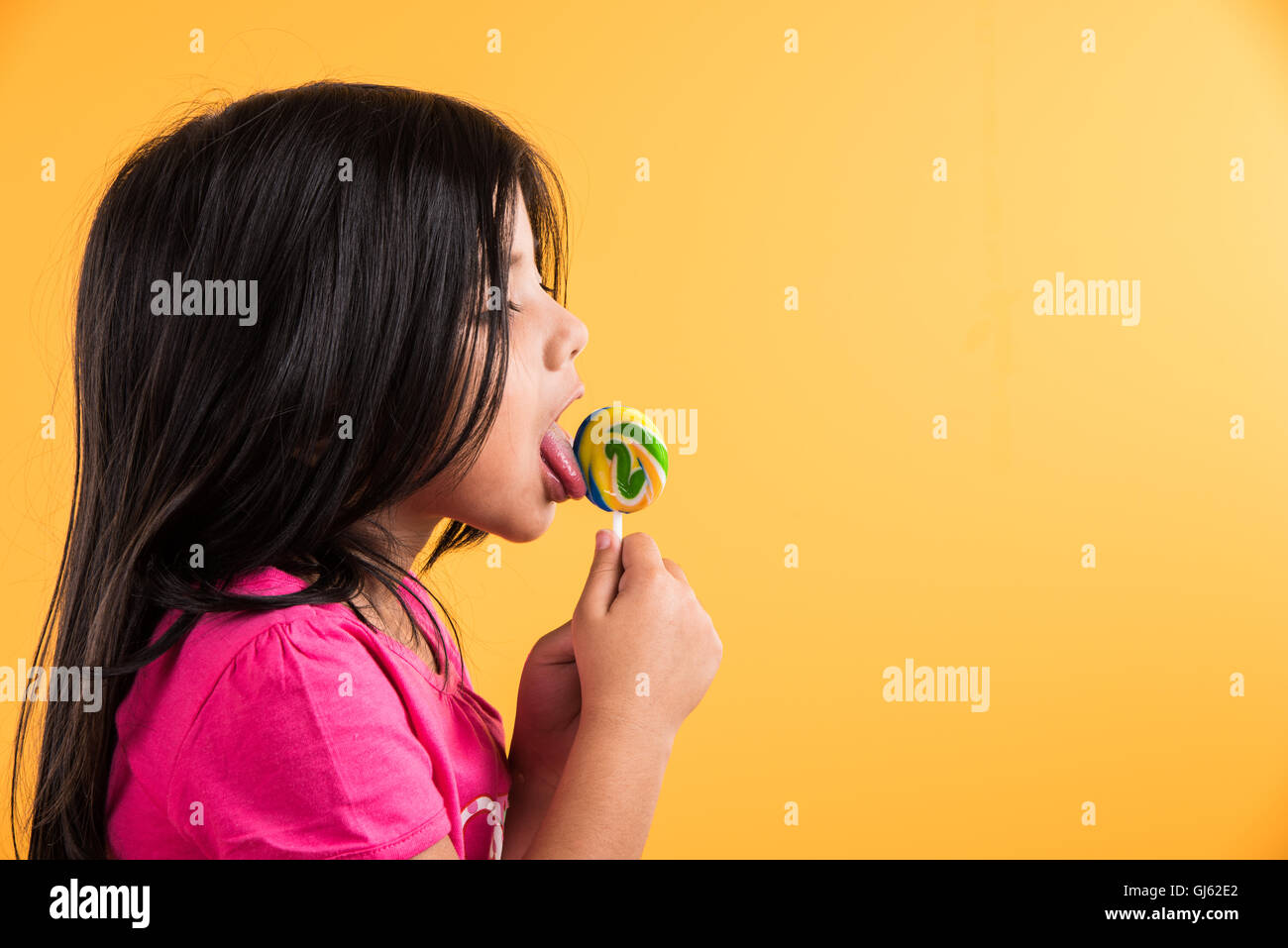 asian candy pop indian small girl with lolipop or loly pop, asian girl and lolipop or  lolypop, playful indian cute girl posing with lolipop Stock Photo - Alamy