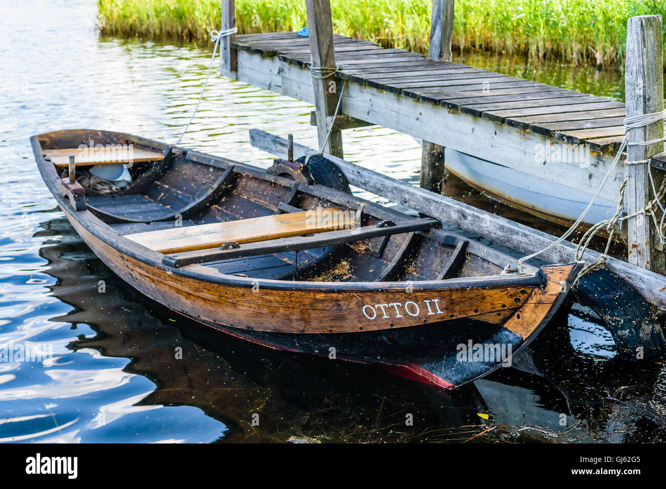 Pataholm, Sweden - August 9, 2016: Traditional wooden skiff named Otto II moored at small pier. Stock Photo