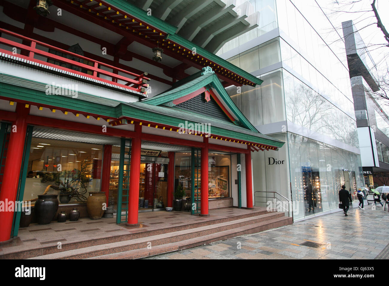 Along Omotesando Avenue are the red 'Oriental Bazaar', that sells traditional Japanese souvenirs next to the frosted glass Dior Stock Photo
