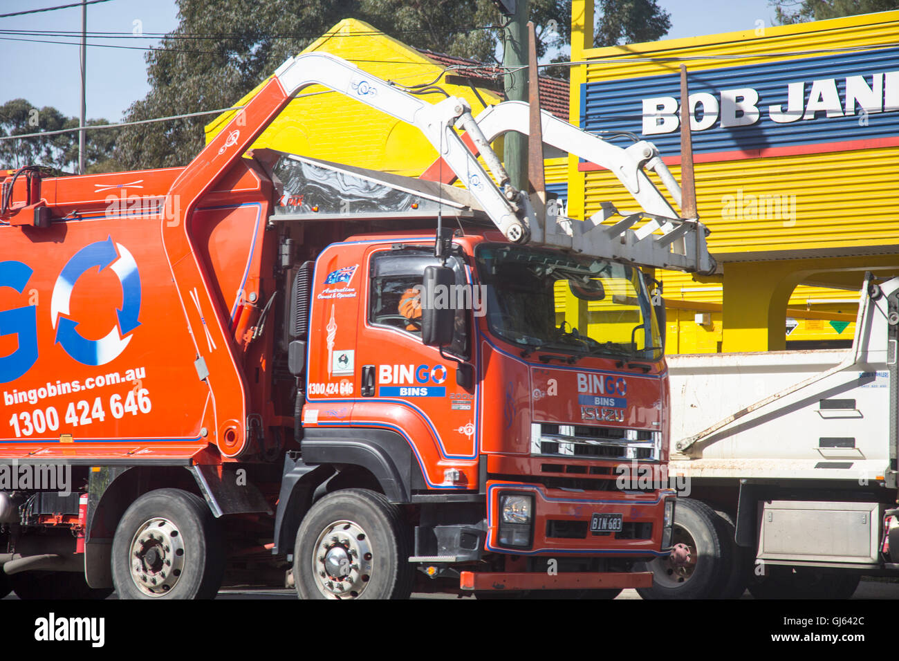 Bingo skip rubbish vehicle driving past a garage in North Sydney