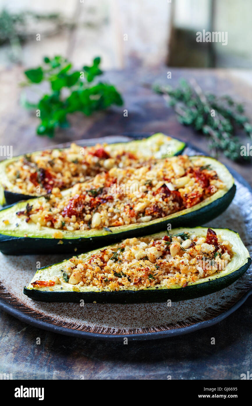Courgettes stuffed with breadcrumbs, pine nuts, sun dried tomatoes and