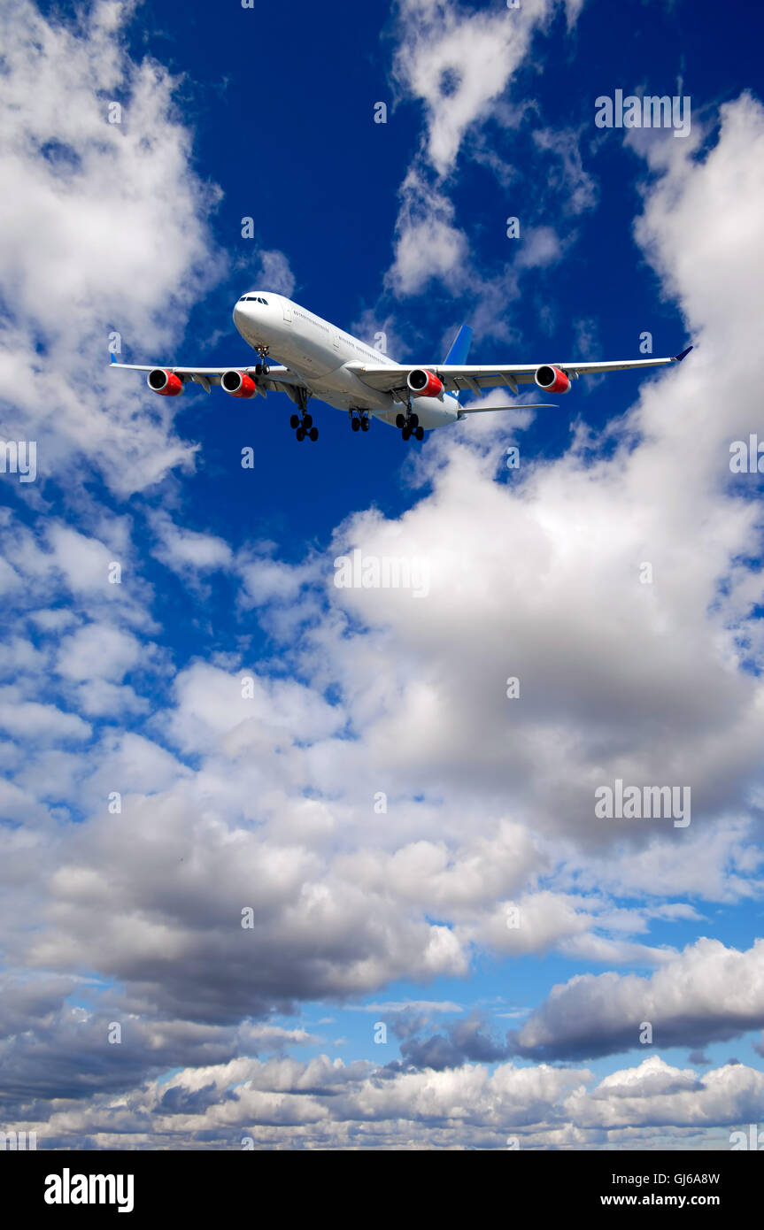 Air travel - Plane is flying in blue sky with clouds Stock Photo - Alamy