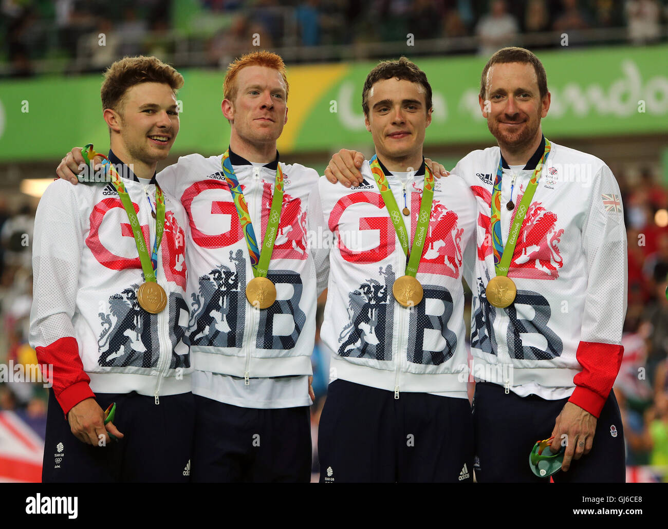 Great Britain's (left-right) Owain Doull, Ed Clancy, Steven Burke and Sir Bradley Wiggins with their gold medals following victory in the men's team pursuit final on the seventh day of the Rio Olympics Games, Brazil. Stock Photo