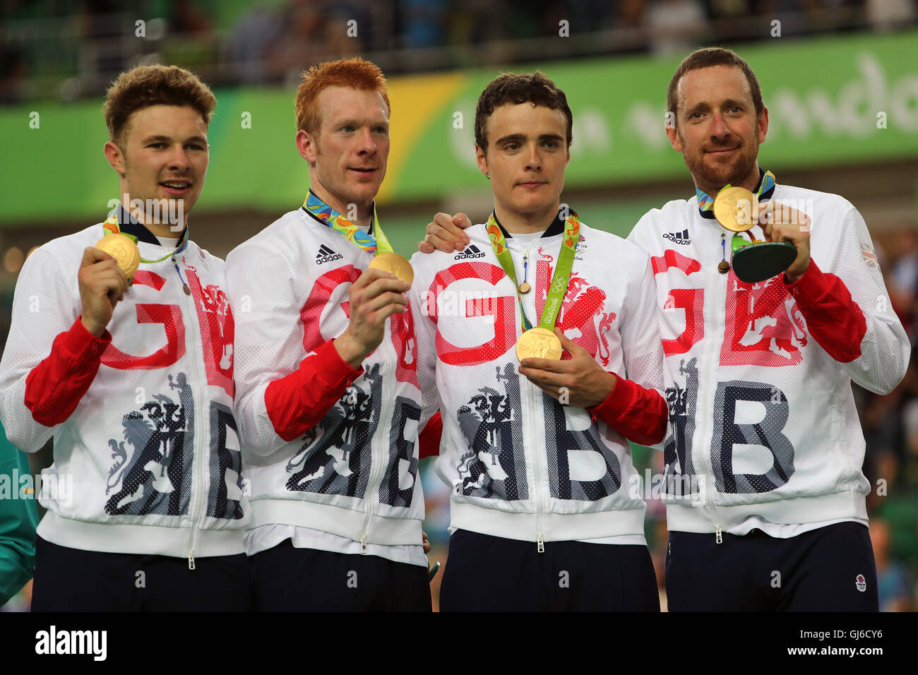 Great Britain's (left-right) Owain Doull, Ed Clancy, Steven Burke and Sir Bradley Wiggins with their gold medals following victory in the men's team pursuit final on the seventh day of the Rio Olympics Games, Brazil. Stock Photo