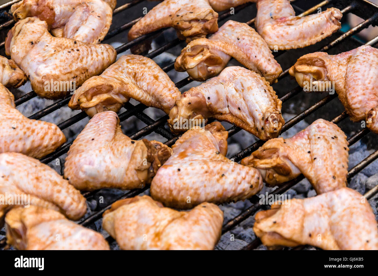 Marinated chicken wings being cooked on a barbeque Stock Photo Alamy