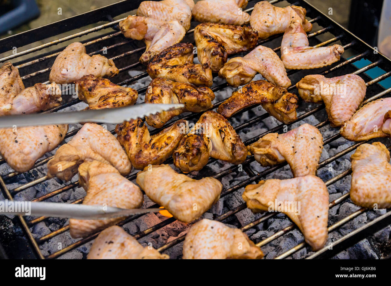 Marinated chicken wings being cooked on a barbeque Stock Photo Alamy