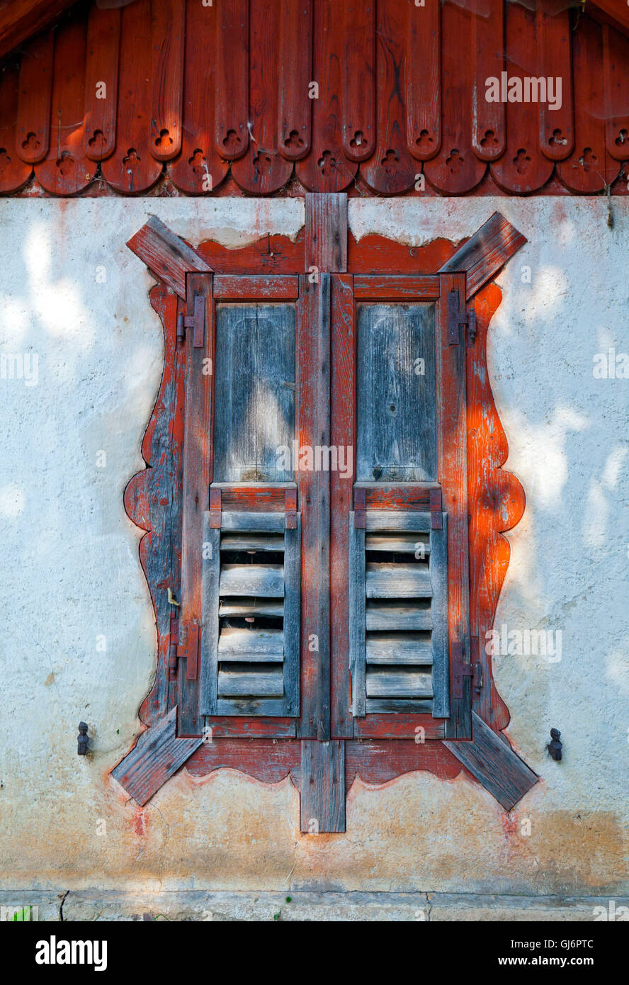 Window in wall of a house with wooden ornaments Stock Photo