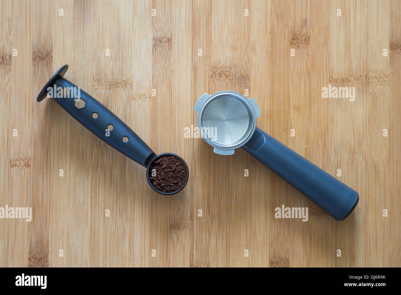 Coffee grounds in a scoop and filter holder of an espresso machine