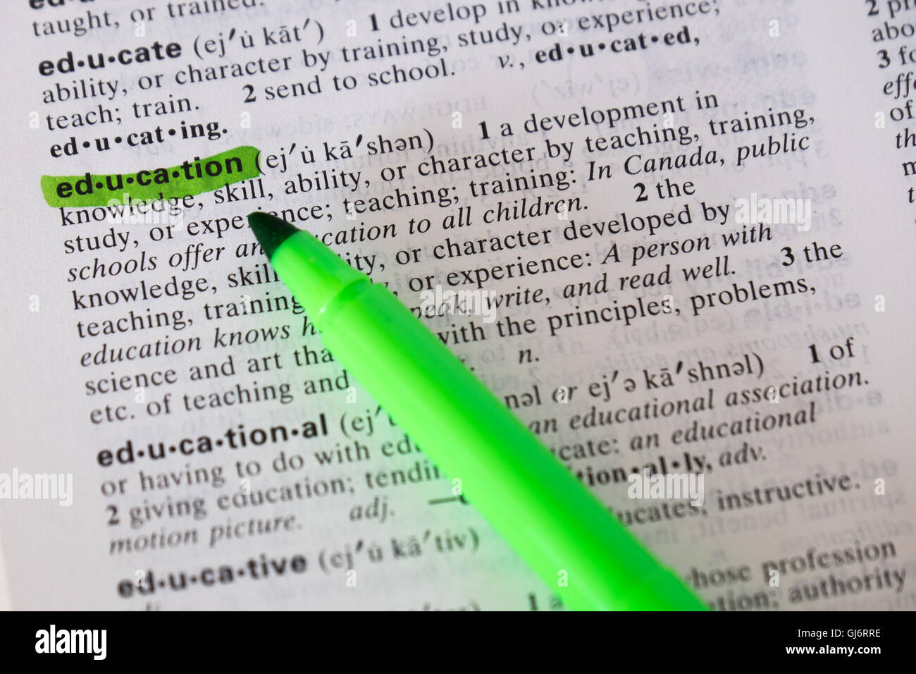 The word education is defined and highlighted in a dictionary. Stock Photo
