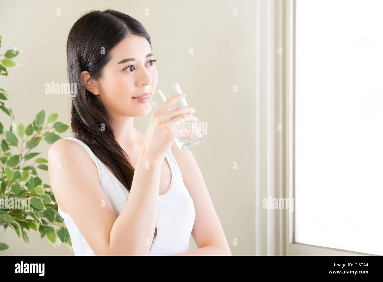 Beautiful portrait asian young woman smiling and drinking water glass with ...