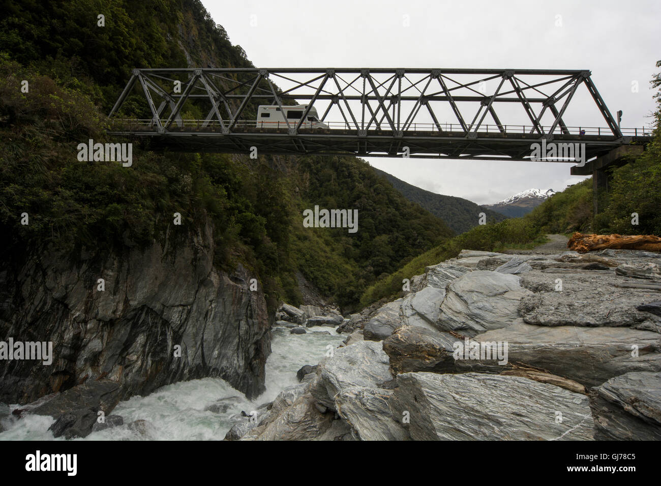 An one-lane-bridge crosses the Haast River at the Gates of Haast as a part of the 563 meters high Haast Pass in New Zealand. Stock Photo
