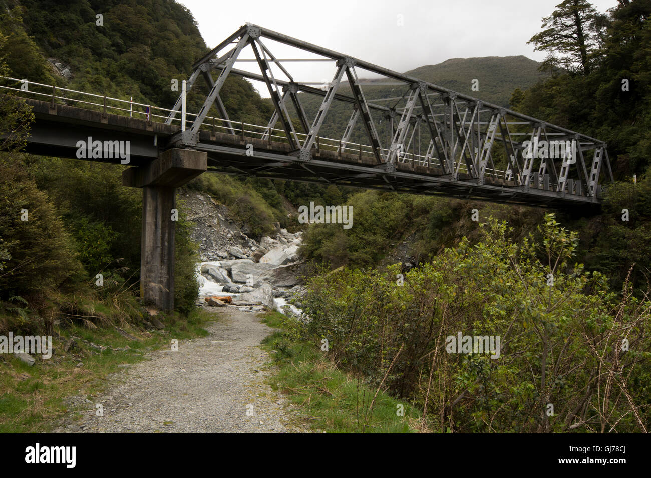 An one-lane-bridge crosses the Haast River at the Gates of Haast as a part of the 563 meters high Haast Pass in New Zealand. Stock Photo