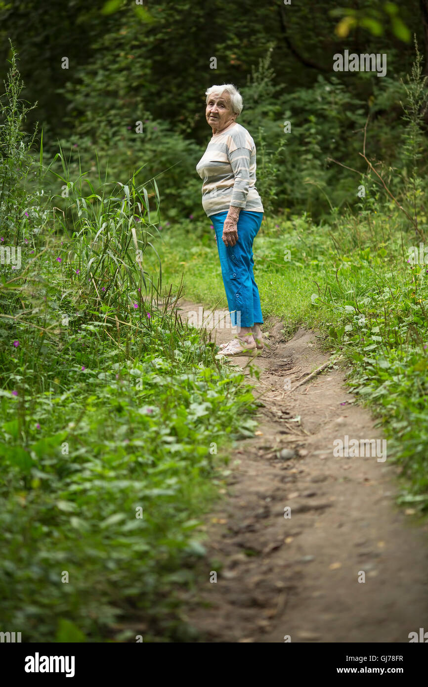 Elderly woman kneeling hi-res stock photography and images - Alamy