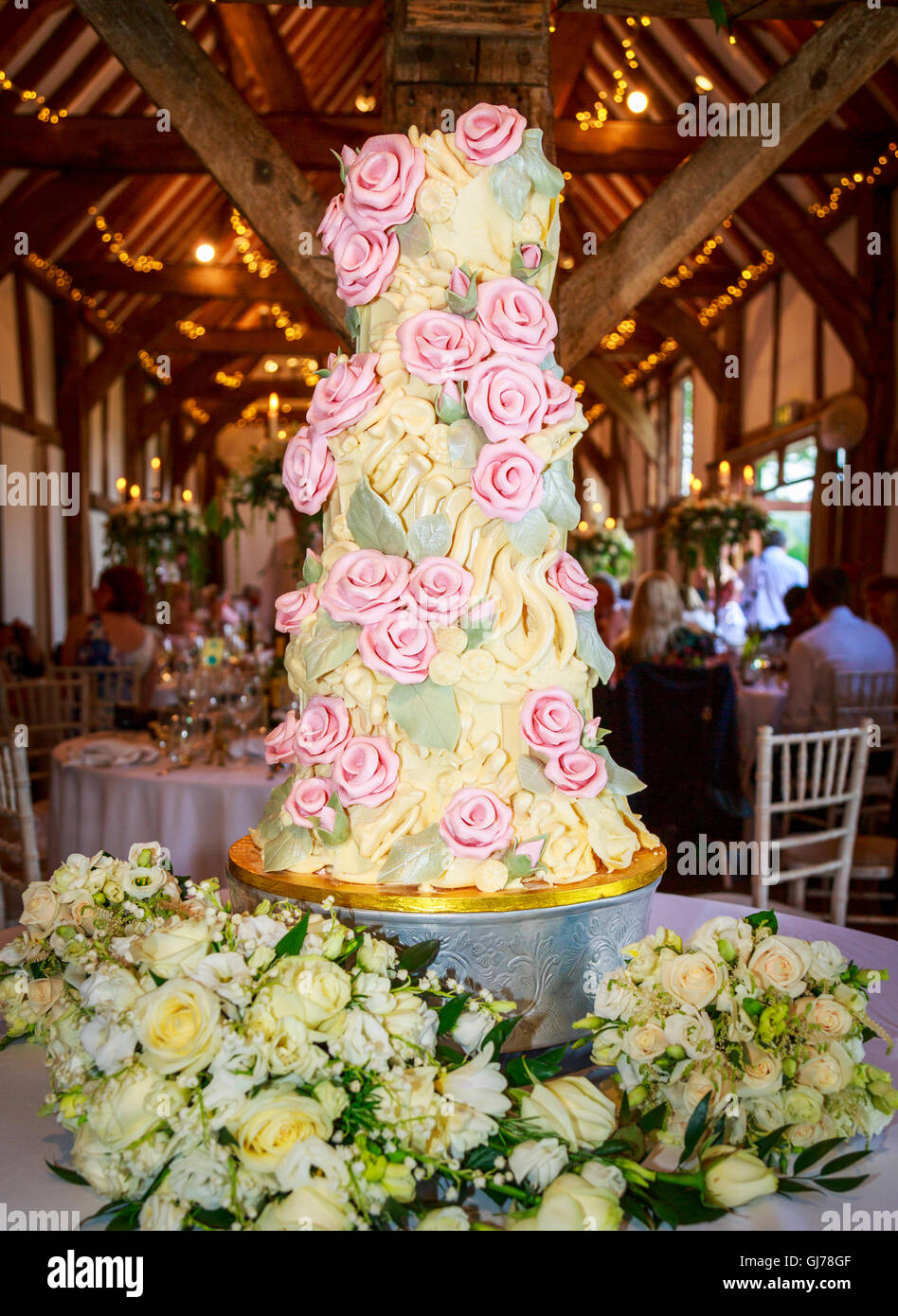 Elaborate bespoke chocolate wedding cake with chocolate pink roses and dinosaur bones including a fossil spine made by Choccywoccydoodah of Brighton Stock Photo