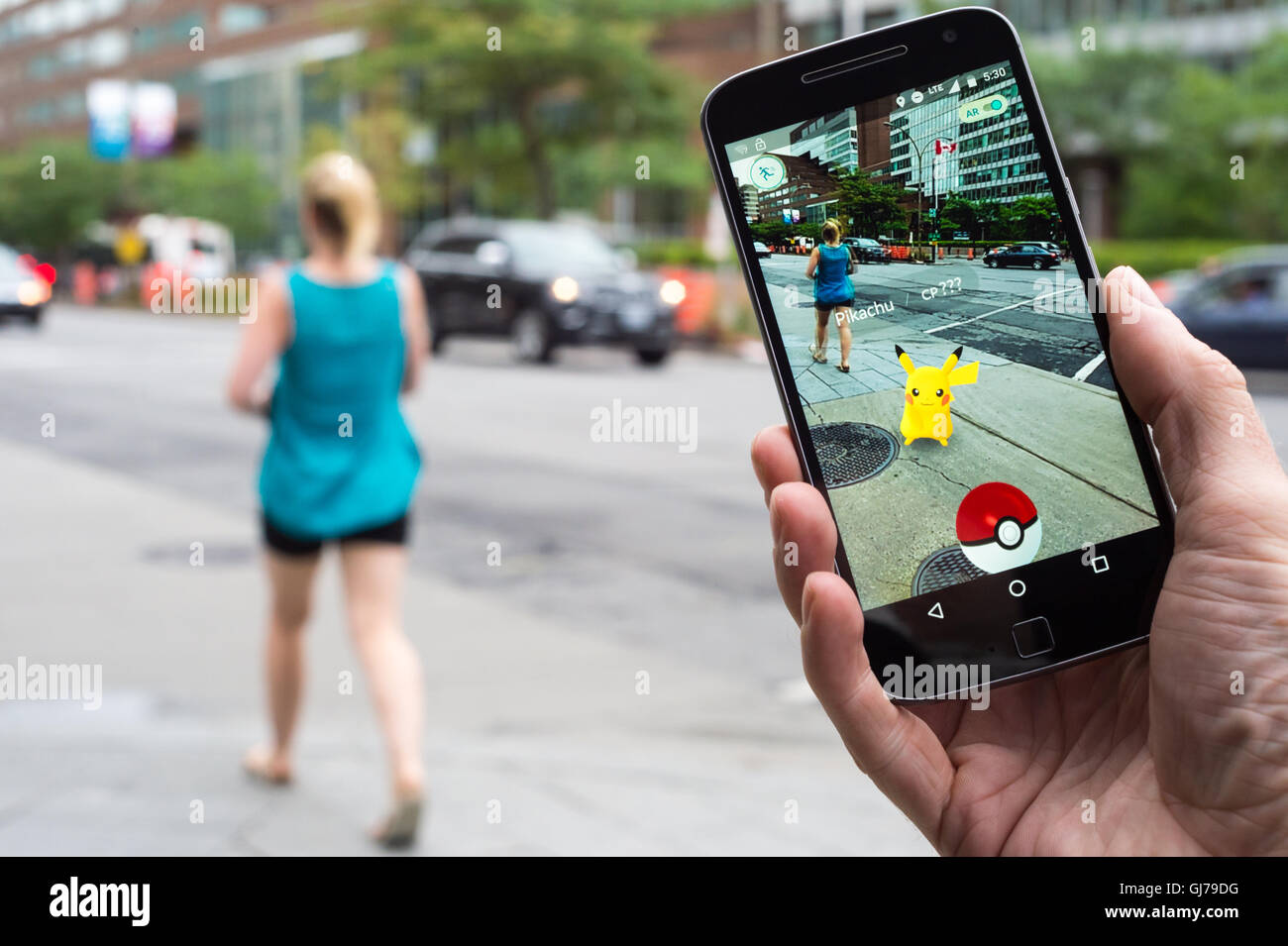 Woman sitting in a car and playing a Pokemon Go game Stock Photo - Alamy