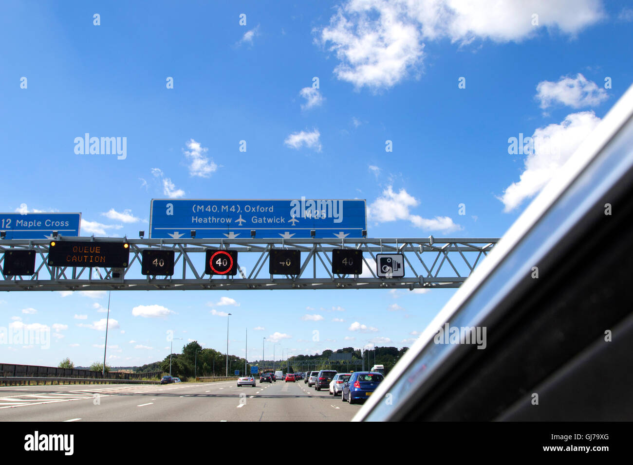 Heavy traffic on the M25 motorway anticlockwise looking south between junctions 15 and 16, near Heathrow Airport in England Stock Photo