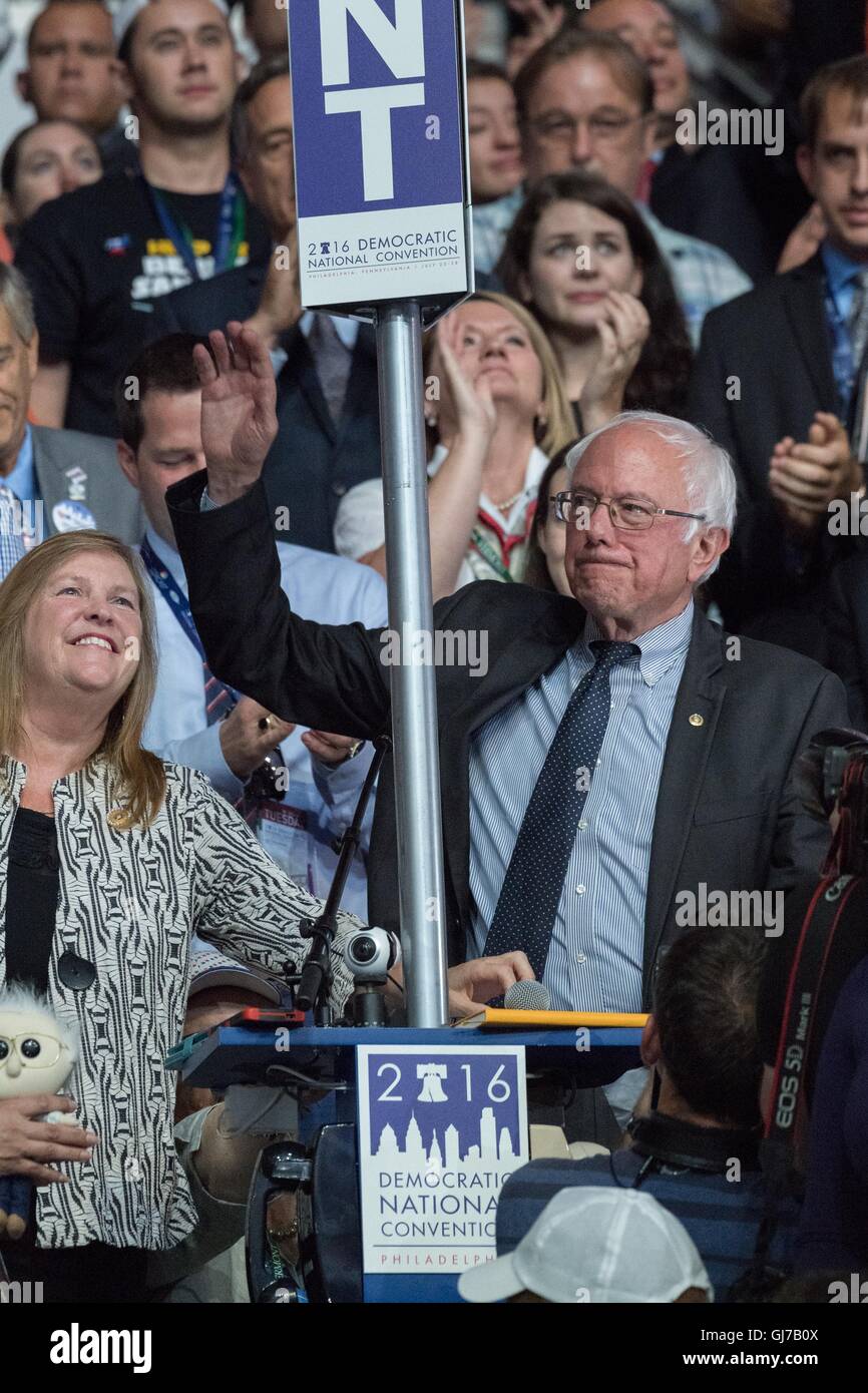 Senator Bernie Sanders and his wife Jane wave as he throws his support behind Democratic presidential nominee Hillary Rodham Clinton from the Vermont delegation during roll call on the 2nd day of the Democratic National Convention at the Wells Fargo Center July 26, 2016 in Philadelphia, Pennsylvania. Stock Photo