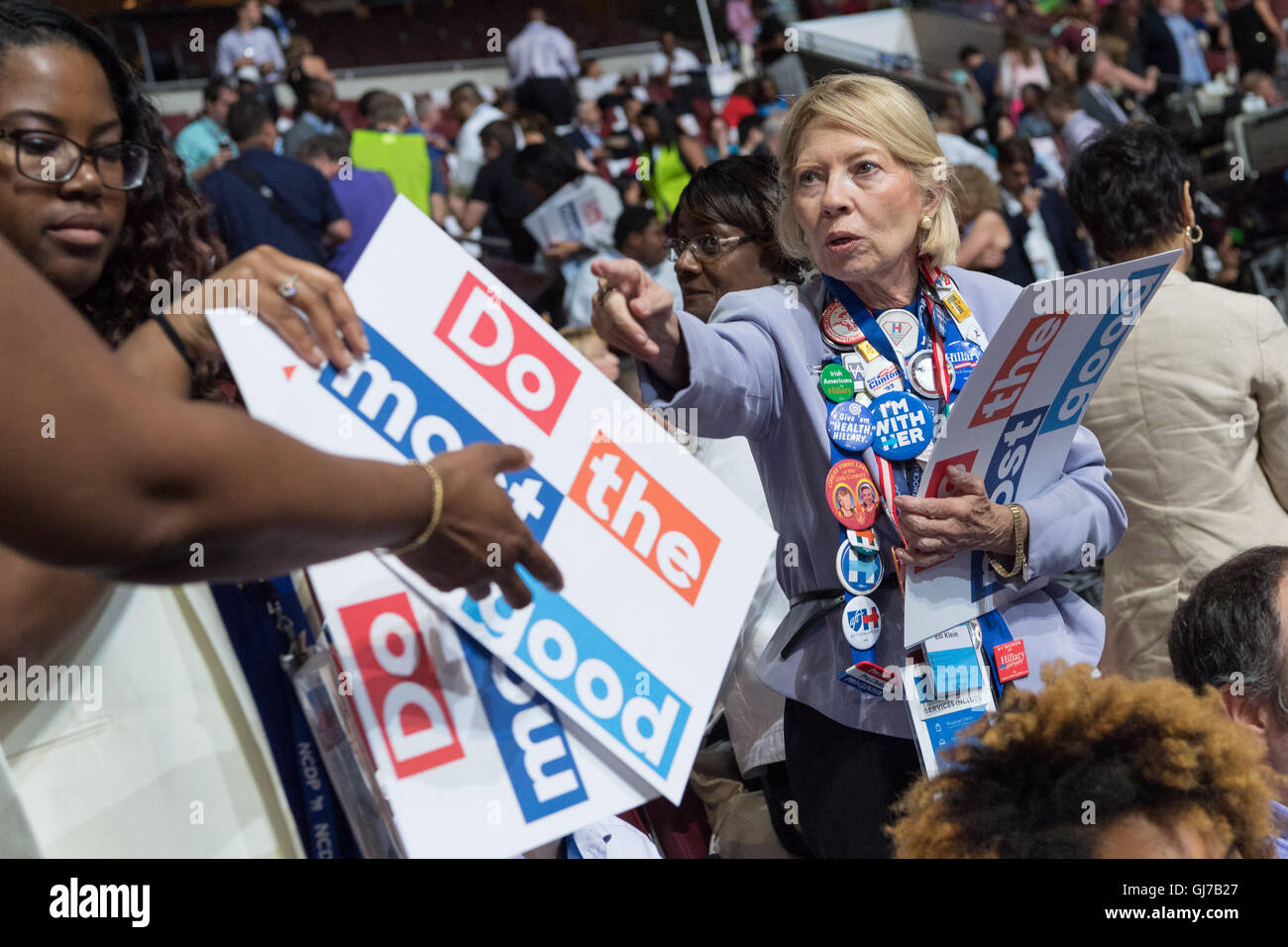 A Democratic delegate hands out signs in the stands before the start of the 2nd day of the Democratic National Convention at the Wells Fargo Center July 26, 2016 in Philadelphia, Pennsylvania. Stock Photo