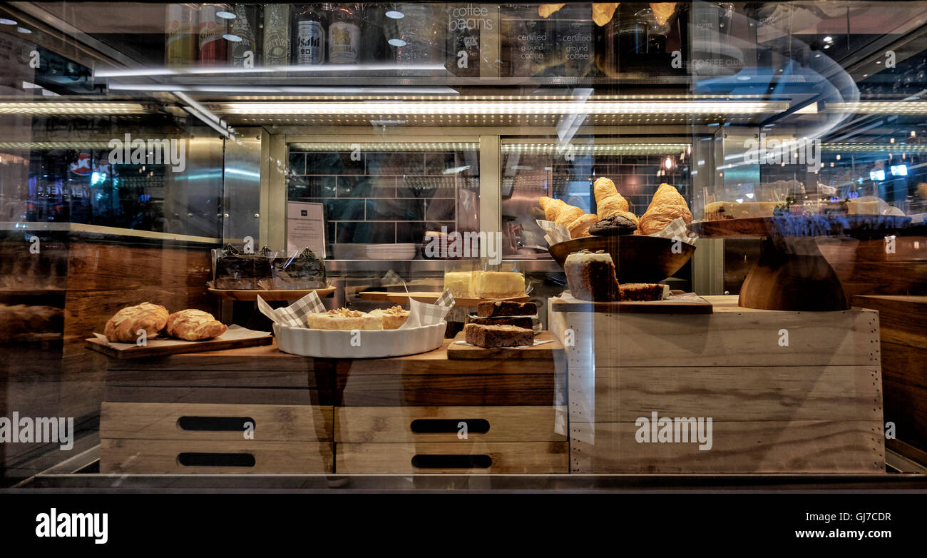 Fancy cakes and croissants behind a glass display cabinet. Stock Photo