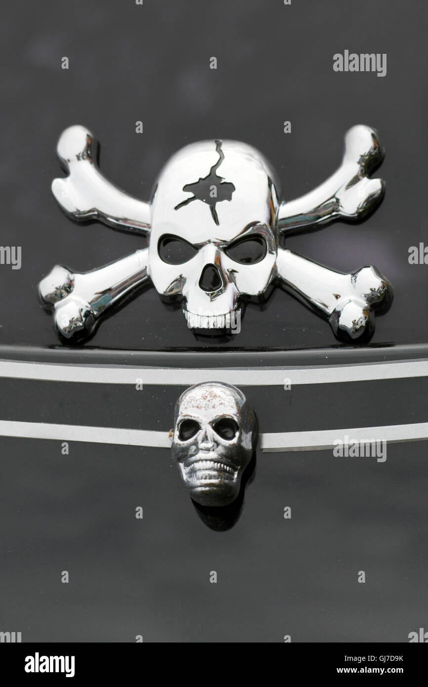 Chrome Cracked skull and crossbones on a Harley Davidson motorcycle Stock Photo