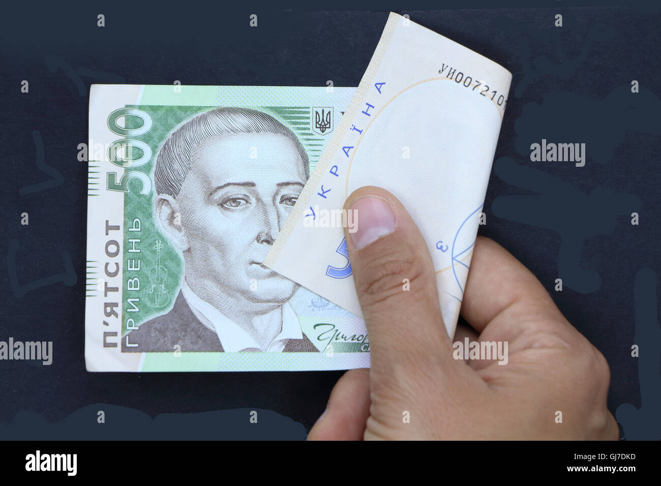 ukrainian money, hand with money, black background, holding money, five hundred hryvnia, ukrainian currency, financial situation Stock Photo