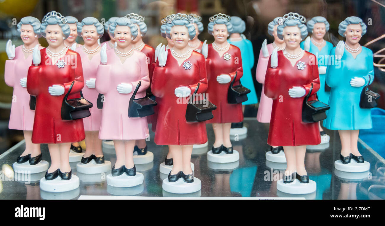 A row of Queen Elizabeth 11 waiving figurines in a shop window Stock Photo